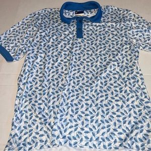 Jack Nicklaus Staydri golf polo. All overprint blue leaves on white. Golden bear